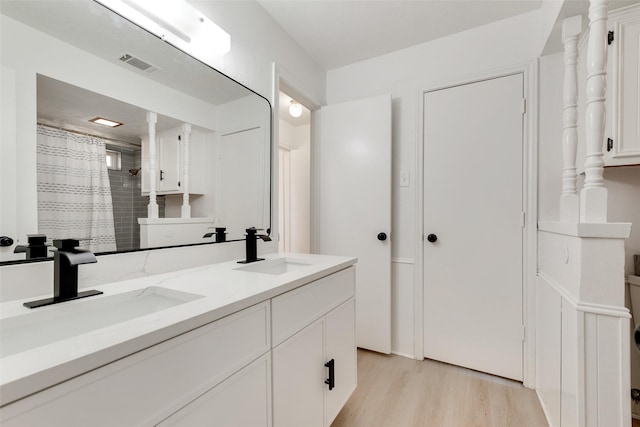 bathroom with vanity and hardwood / wood-style flooring