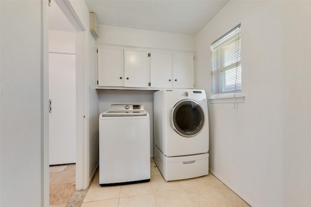 washroom featuring light tile patterned floors, cabinets, and independent washer and dryer