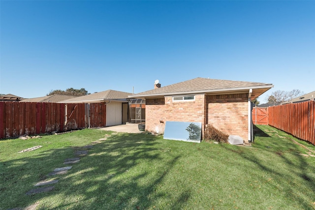 rear view of property with a yard