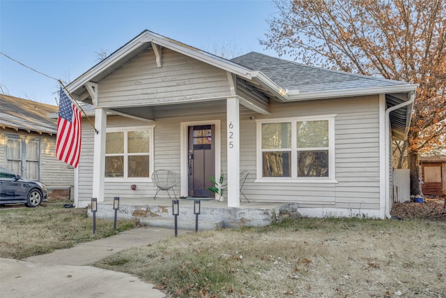 bungalow with a porch and a front yard