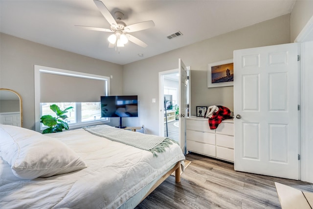 bedroom with ceiling fan and light wood-type flooring