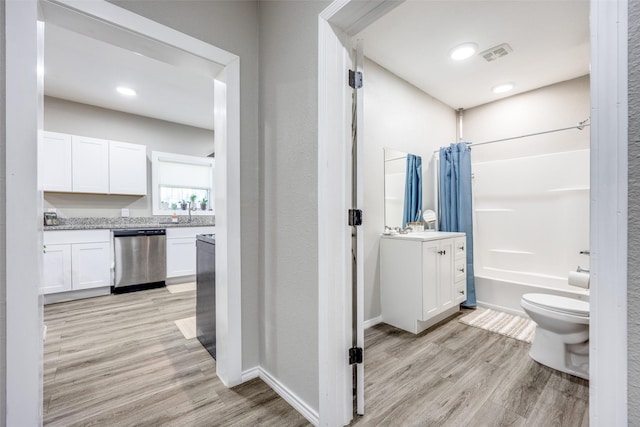 625 S Montgomery St, Sherman, TX 75090 - bathroom with vanity, toilet, shower / bath combo with shower curtain, wood finished floors, and baseboards