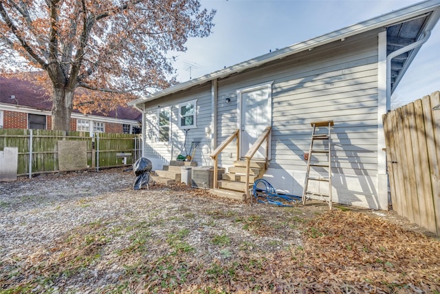 rear view of property featuring central AC unit