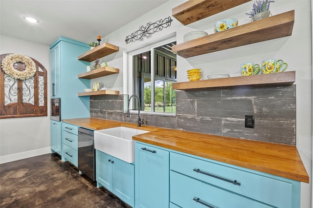 kitchen featuring sink, dishwasher, wood counters, blue cabinets, and decorative backsplash