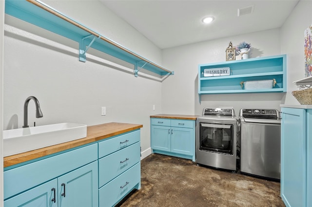 laundry area with washer and dryer, cabinets, and sink