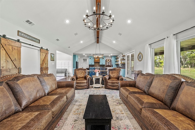 living room featuring lofted ceiling with beams, a barn door, and an inviting chandelier