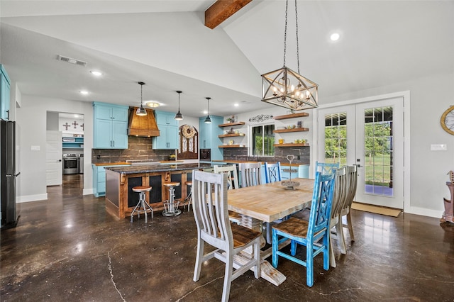 dining area with lofted ceiling with beams, an inviting chandelier, and french doors