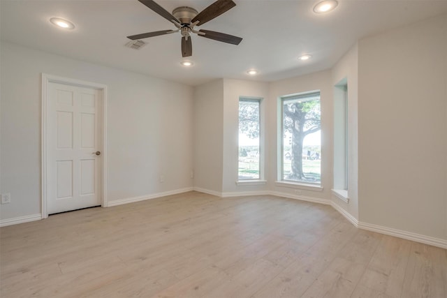 spare room featuring ceiling fan and light hardwood / wood-style floors