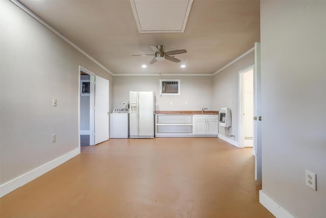 interior space featuring heating unit, crown molding, white refrigerator with ice dispenser, white cabinets, and washer / dryer