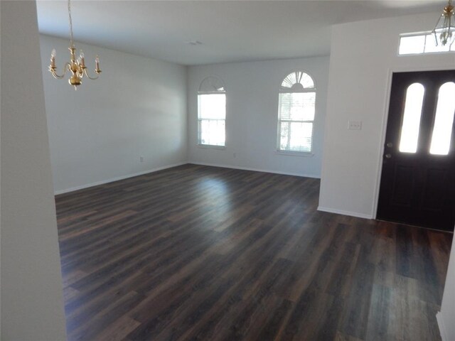 entrance foyer featuring dark hardwood / wood-style flooring and a notable chandelier