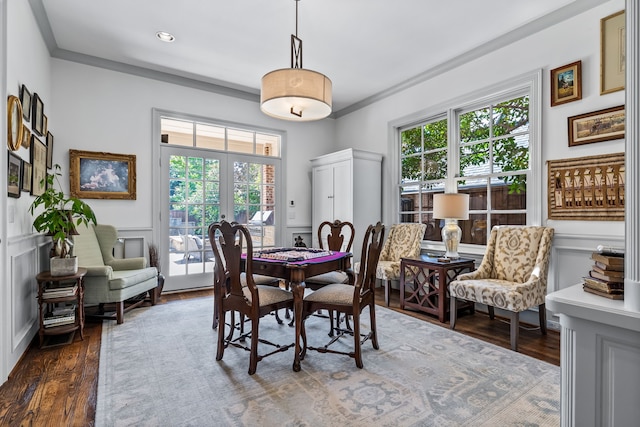 dining space featuring french doors, a healthy amount of sunlight, dark hardwood / wood-style floors, and ornamental molding