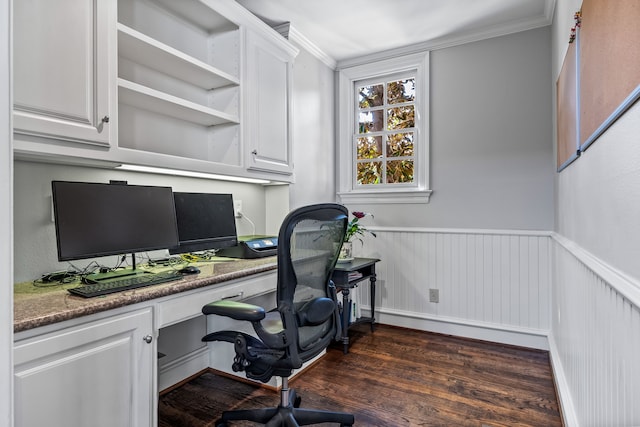 office area featuring built in desk, dark hardwood / wood-style floors, and ornamental molding