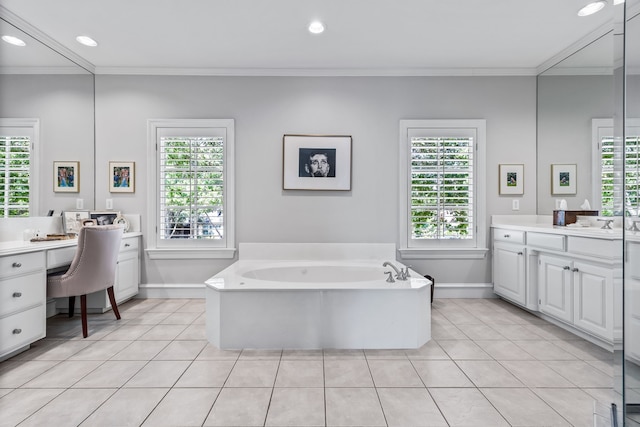 bathroom featuring a healthy amount of sunlight, vanity, a bathtub, and ornamental molding