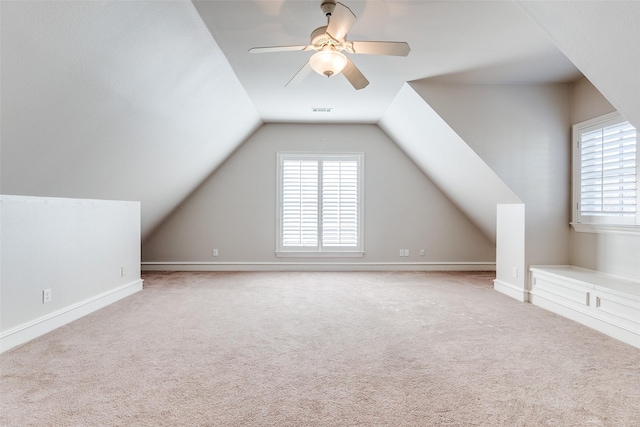 bonus room with ceiling fan, lofted ceiling, and light carpet