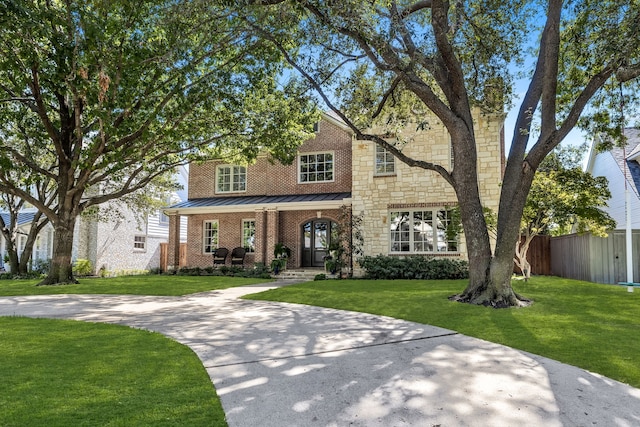 view of front of home with a porch and a front lawn