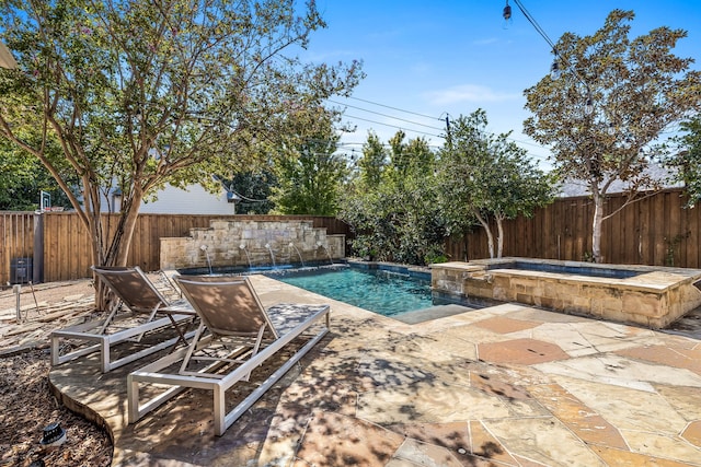 view of swimming pool featuring a patio area, an in ground hot tub, and pool water feature