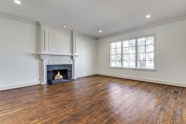 unfurnished living room with dark hardwood / wood-style floors, crown molding, and a tiled fireplace