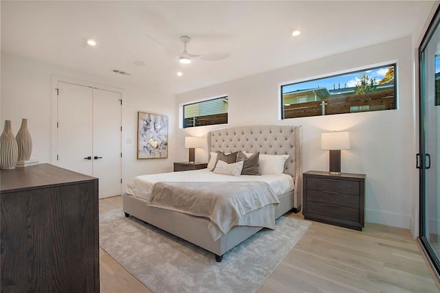 bedroom featuring a closet, ceiling fan, and light hardwood / wood-style flooring