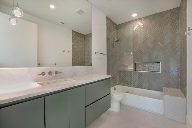 full bathroom with vanity, toilet, and tiled shower / bath combo