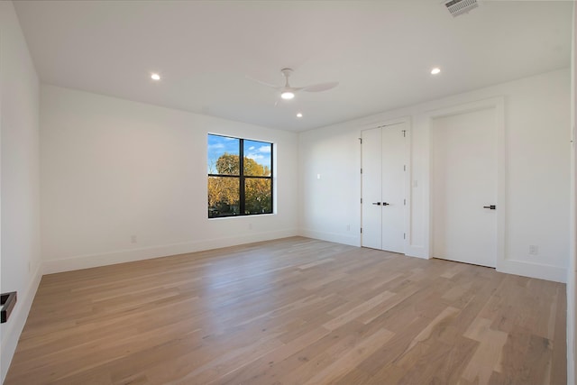 unfurnished bedroom with ceiling fan and light wood-type flooring