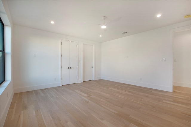 spare room featuring ceiling fan and light hardwood / wood-style flooring