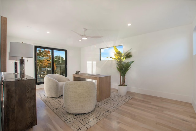 living room with ceiling fan and light hardwood / wood-style floors