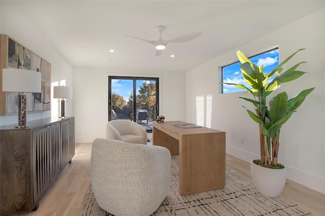 home office featuring ceiling fan and light hardwood / wood-style floors