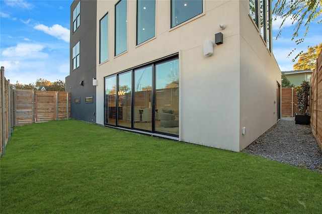 rear view of house with a lawn