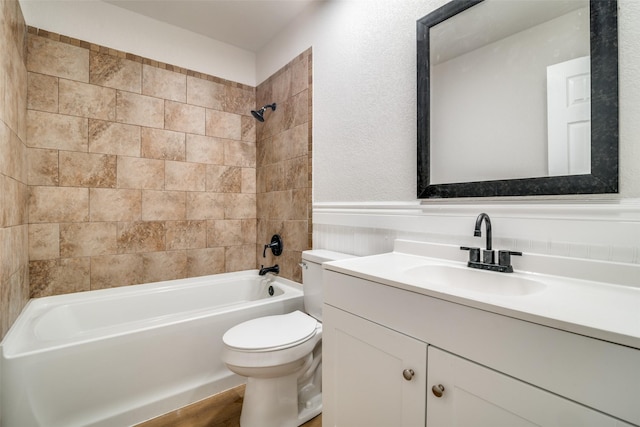 full bathroom featuring toilet, vanity, wood-type flooring, and tiled shower / bath