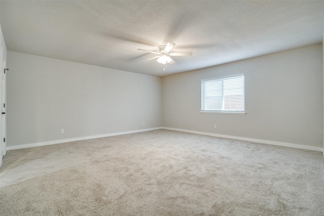 empty room with ceiling fan, carpet, and a textured ceiling