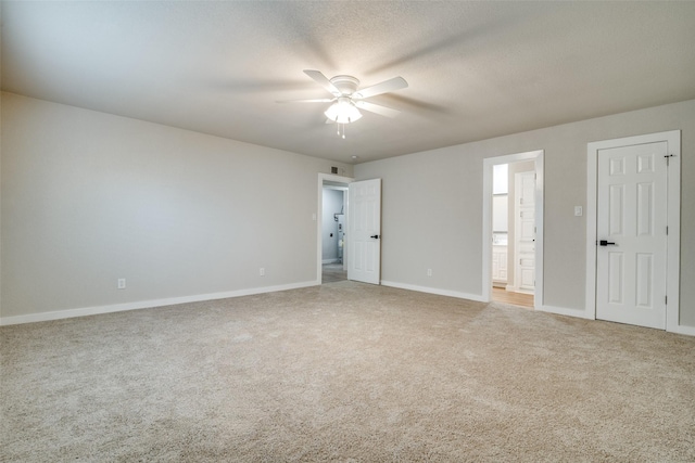 carpeted spare room with ceiling fan and a textured ceiling