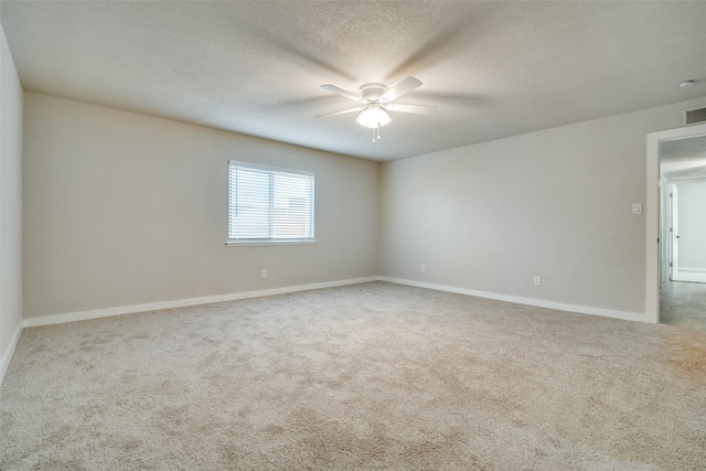 carpeted spare room with ceiling fan and a textured ceiling