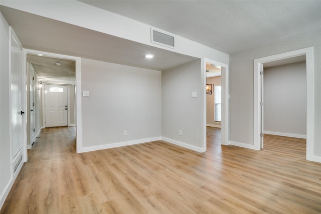 spare room featuring light hardwood / wood-style floors