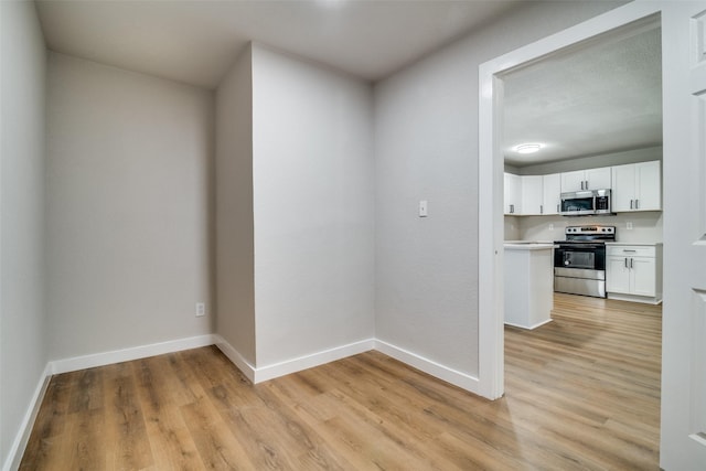 spare room featuring light hardwood / wood-style floors