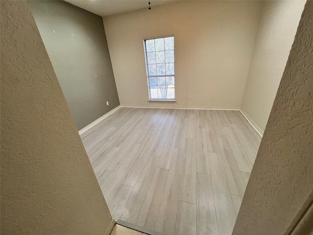 empty room with light hardwood / wood-style flooring