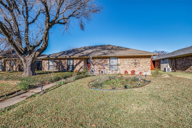 ranch-style house with central AC unit and a front yard