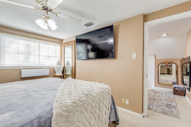 bedroom with ceiling fan, a textured ceiling, and light carpet