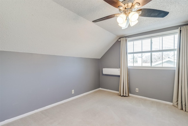 bonus room with ceiling fan, light colored carpet, vaulted ceiling, and a textured ceiling