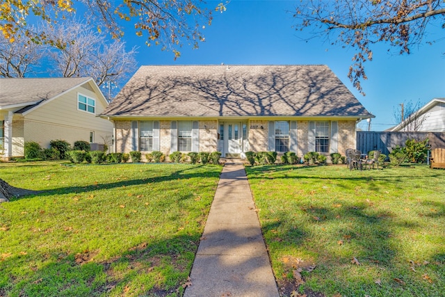 view of front of property with a front yard and brick siding