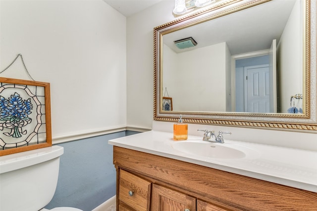 bathroom featuring toilet and vanity