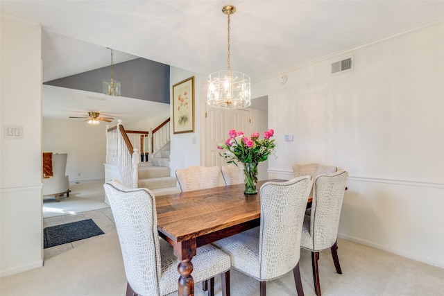 dining room with light carpet, crown molding, and ceiling fan with notable chandelier