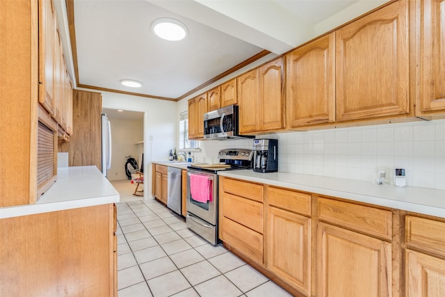 kitchen with tasteful backsplash, appliances with stainless steel finishes, light tile patterned flooring, and ornamental molding