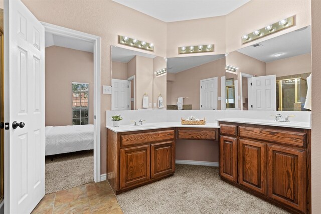 ensuite bathroom featuring double vanity, ensuite bathroom, and a sink