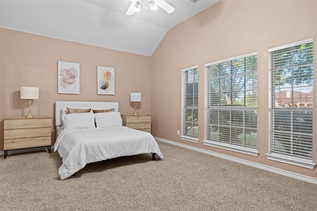 carpeted bedroom featuring ceiling fan and vaulted ceiling