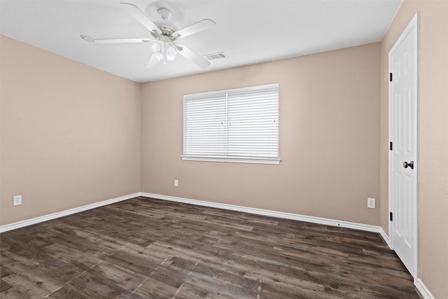 empty room with visible vents, baseboards, dark wood-style floors, and a ceiling fan