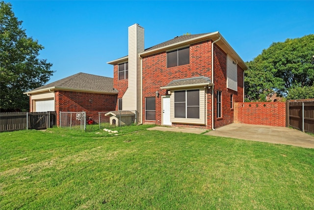 rear view of house featuring brick siding, a fenced backyard, a patio area, and a yard