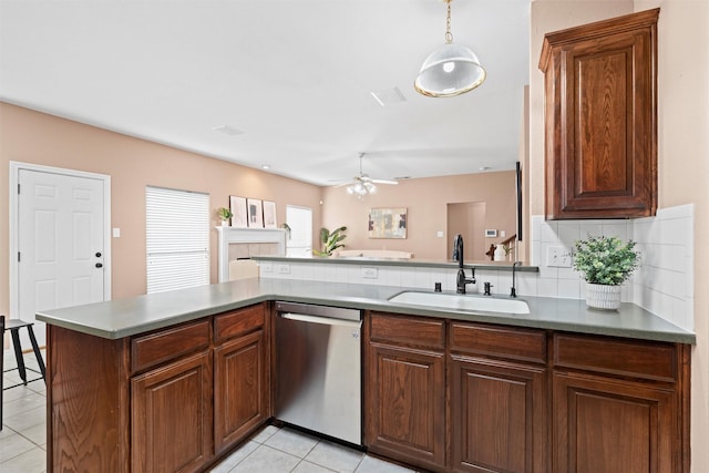 kitchen featuring a sink, tasteful backsplash, light tile patterned floors, dishwasher, and ceiling fan