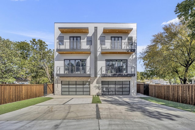 modern home featuring a balcony and a garage