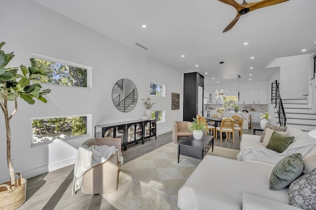 living room with ceiling fan and light hardwood / wood-style flooring