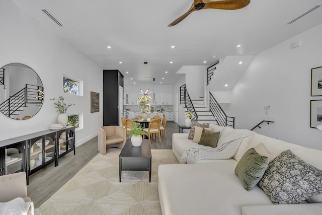 living room featuring ceiling fan and light hardwood / wood-style floors